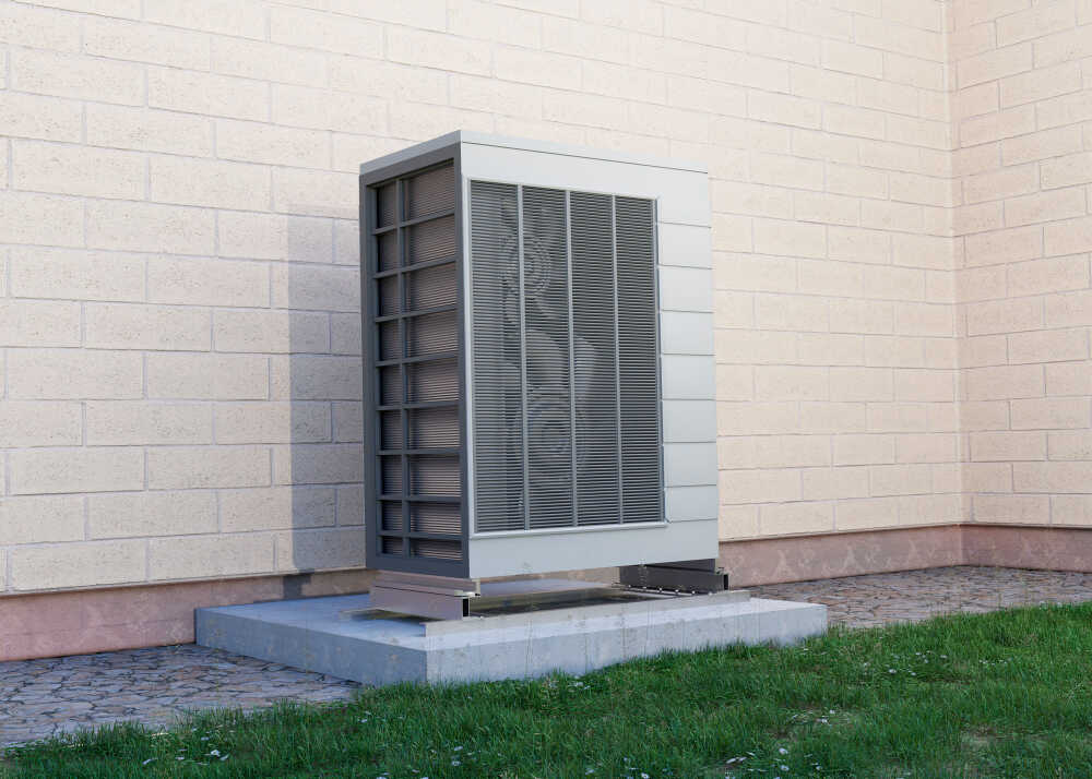zbliżenie na pionową pompę ciepła zamontowaną na zewnątrz domu jednorodzinego